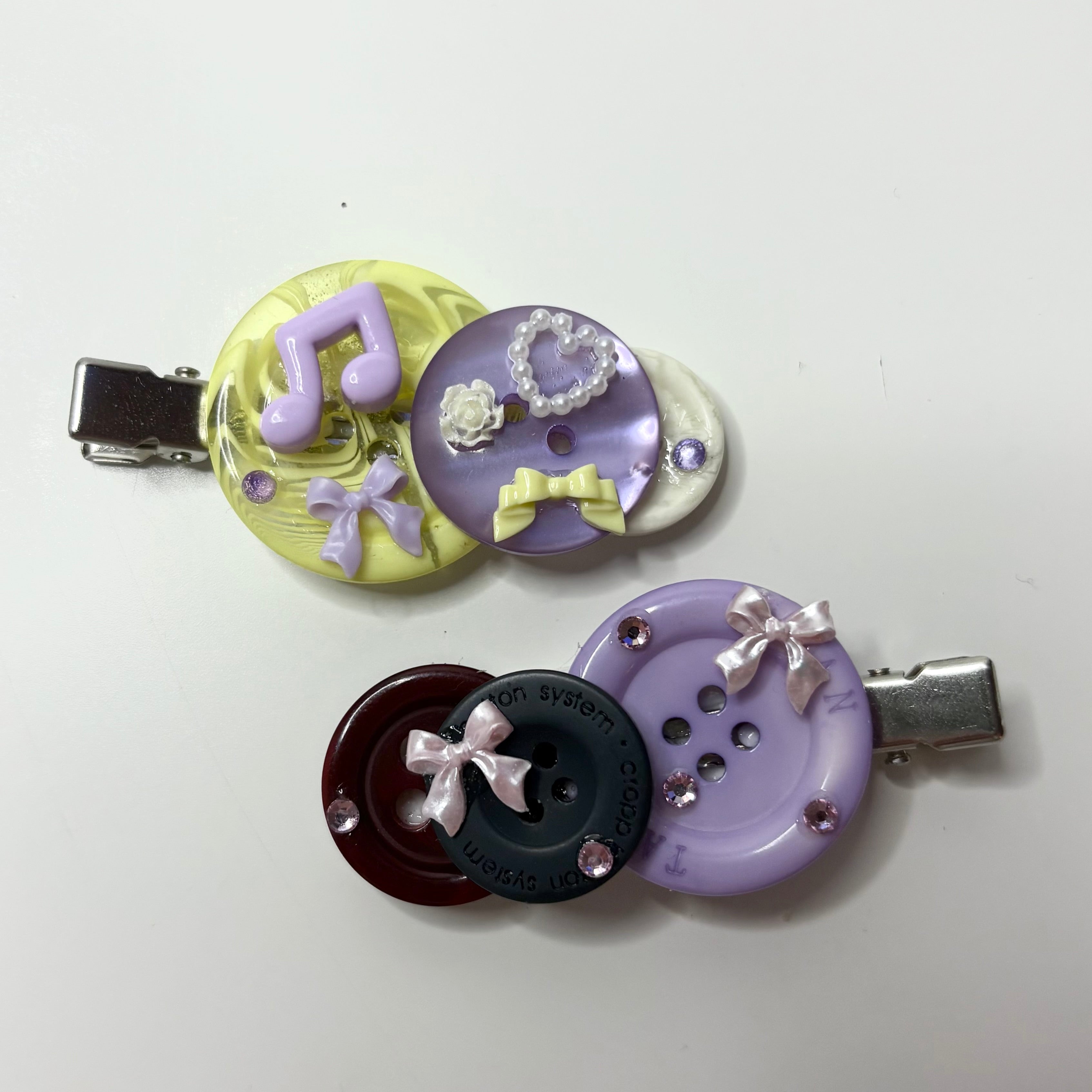 purple button clip duo