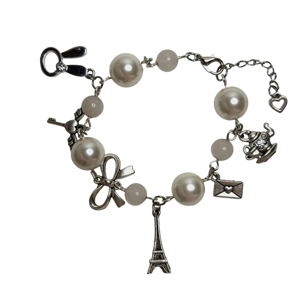 Bracelet with pearl beads and charms on a white background