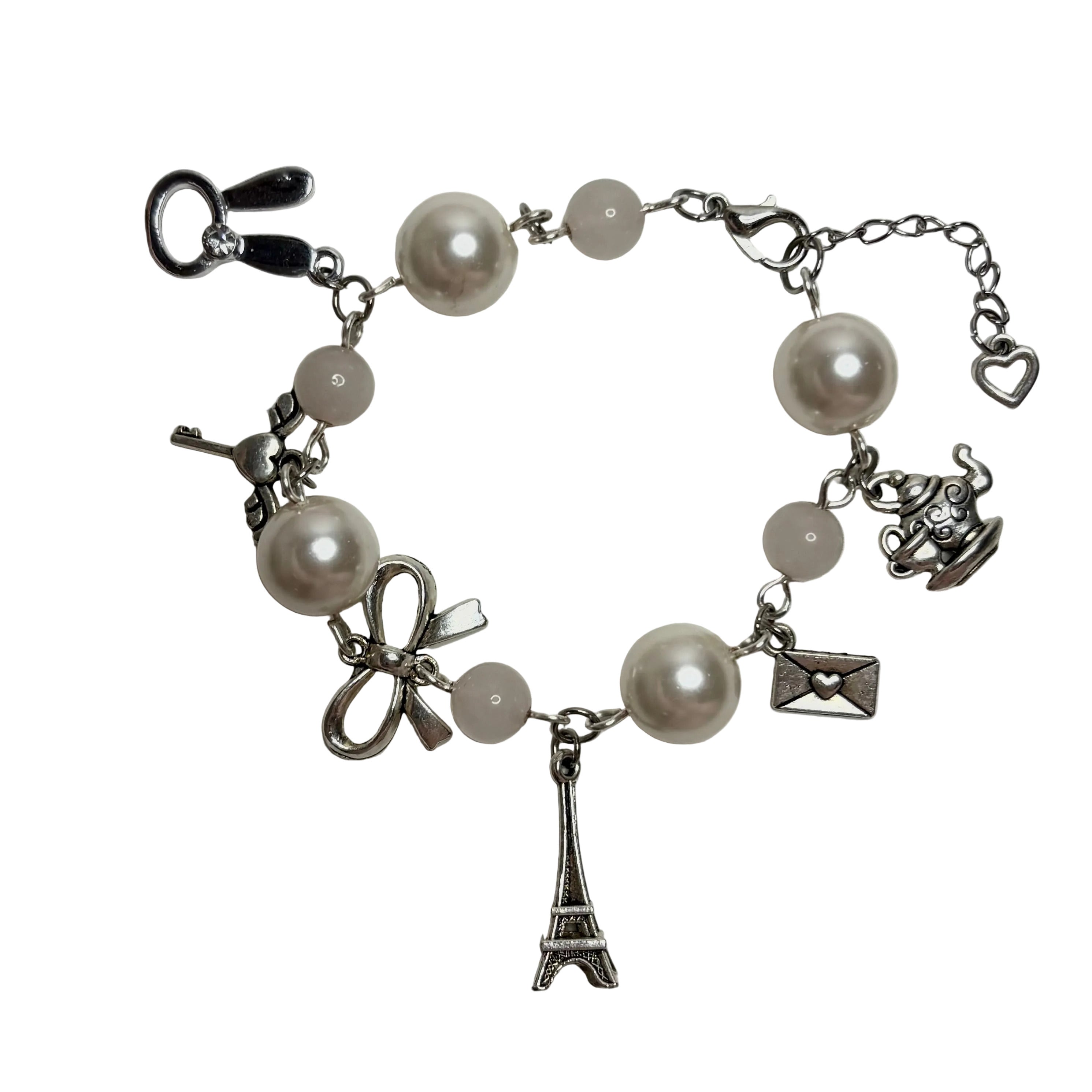 Bracelet with pearl beads and charms on a white background